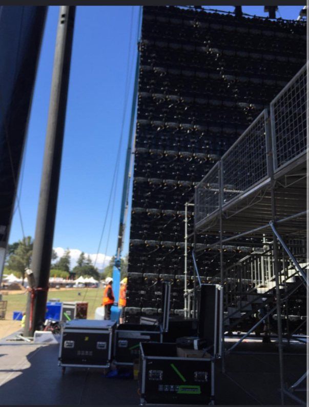 The back of a towering stadium LED wall and road cases at Oracle Park for an AC/DC show